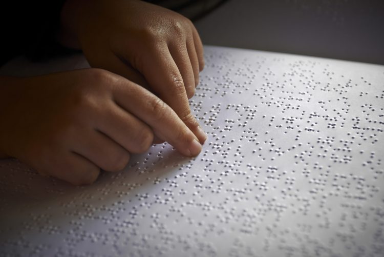 a child reading braille