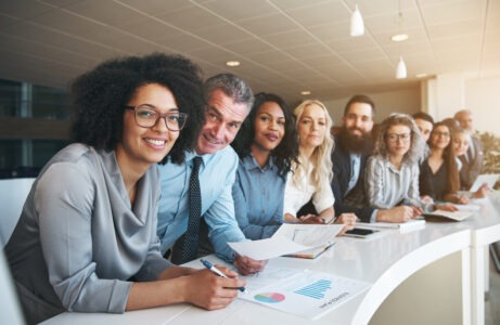 Smiling group of colleagues sitting side by side